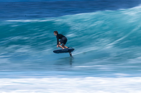 Duotone Crush SLS prone foil board during wave foiling in Guadeloupe