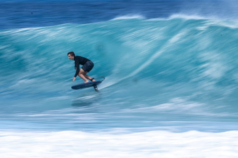 Duotone Crest SLS front wing during prone foiling in turquoise waves in Guadeloupe