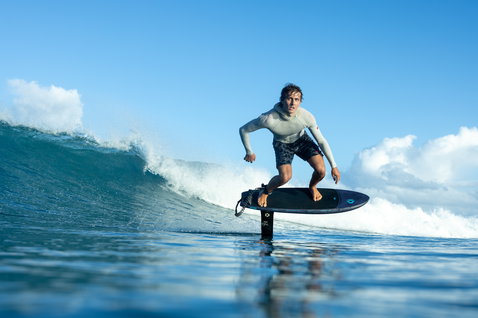 Duotone Crush SLS front wing during prone foiling on a tropical ocean wave in Guadeloupe
