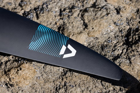 Duotone Crest SLS front wing in matte carbon black with cyan graphic, detail shot of wing tip