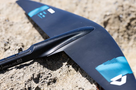 Duotone Crest SLS front wing in dark charcoal and cyan, detail view of carbon body and fuselage