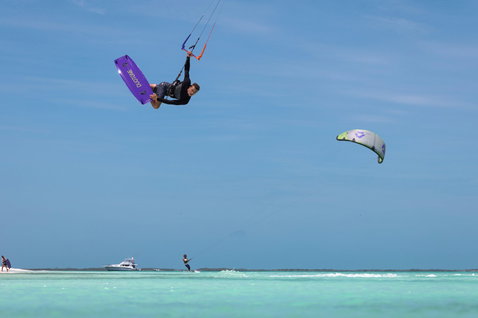 Duotone Trust Bar control bar during kitesurfing over tropical turquoise water