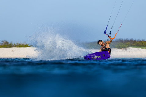 Duotone Trust Bar Quad Control kite control bar during kitesurfing action on tropical ocean waters