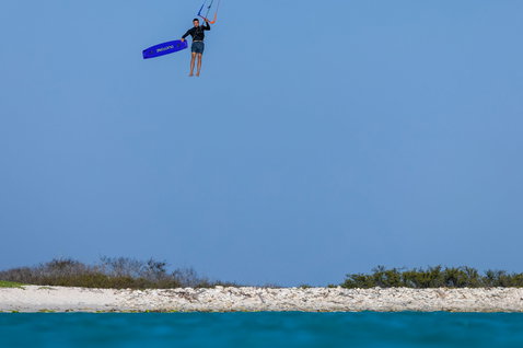 Duotone Trust Bar quad control bar during kitesurfing Big Air jump at a tropical coastal beach