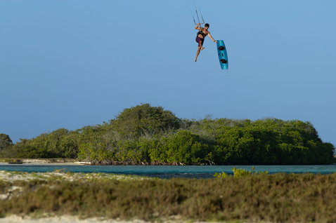 Duotone Click Bar Quad Control during kitesurfing Big Air jump above tropical lagoon