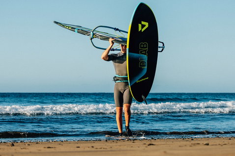 Duotone Skate D/LAB freestyle windsurf board during windsurfing at the beach