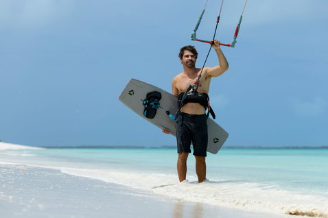 Duotone Entity 360 Jaime SLS twin-tip kiteboard lors d'une session de kitesurf sur une plage tropicale