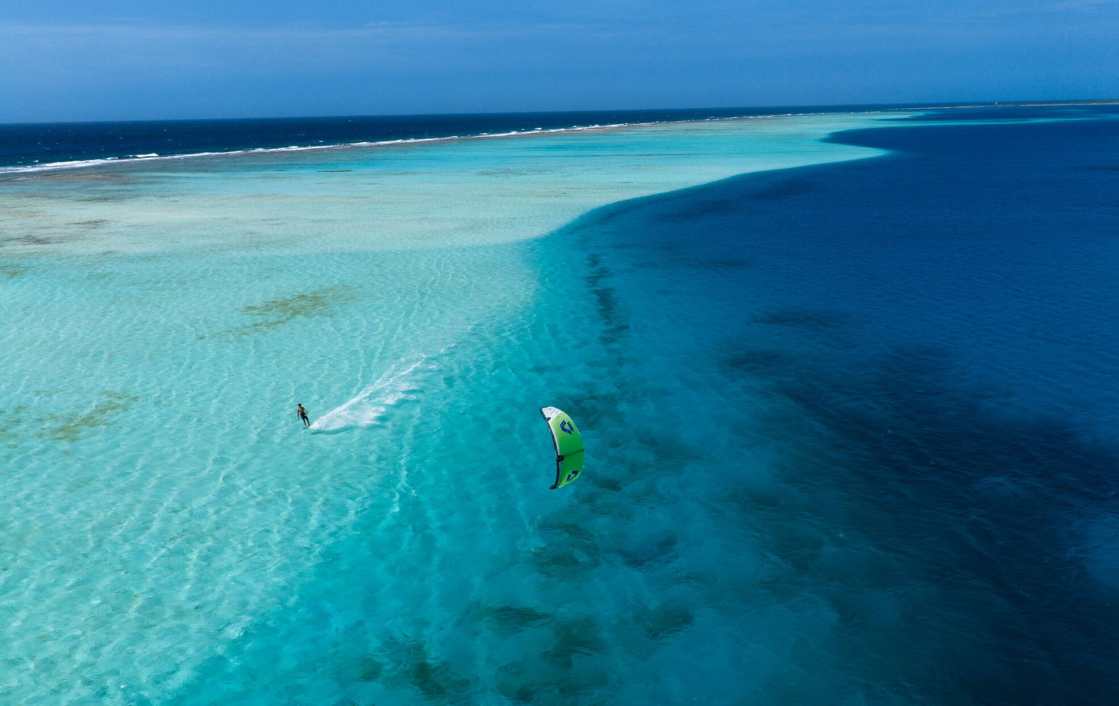 Duotone Blur SLS wave kiteboard during kitesurfing over a tropical reef lagoon