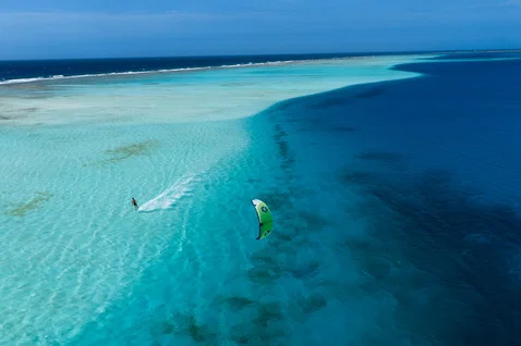 Duotone Blur SLS wave kiteboard during kitesurfing over a tropical reef lagoon