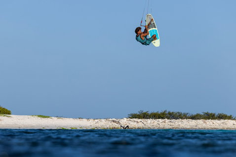 Duotone Traction Pad Front for surfboards during strapless freestyle kitesurfing over a tropical lagoon