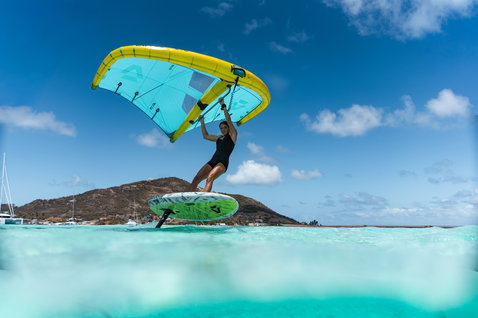 Duotone Skybrid D/LAB foil board during wing foiling in a tropical turquoise lagoon