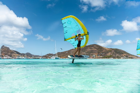 Duotone Skybrid D/LAB foil board during wing foiling in a turquoise Caribbean lagoon