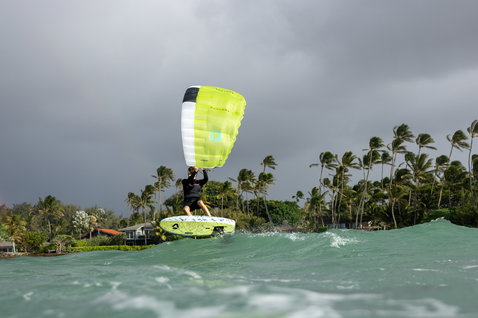 Duotone Skybrid D/LAB foil board during wing foiling in a tropical lagoon with rainbow