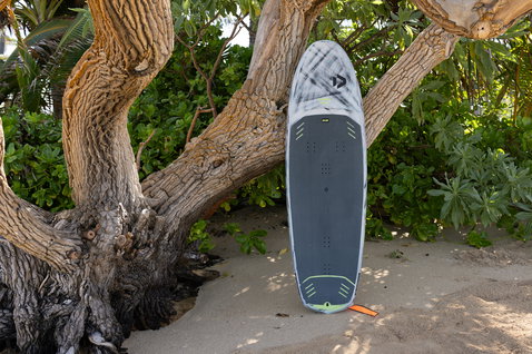 Duotone Skybrid D/LAB foil board in charcoal grey with carbon construction on the beach in Maui