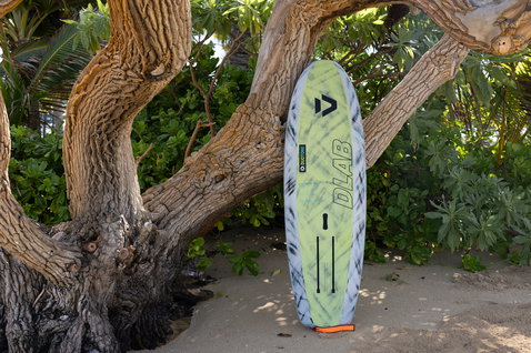 Duotone Skybrid D/LAB foil board in dark charcoal and lime green at Maui beach
