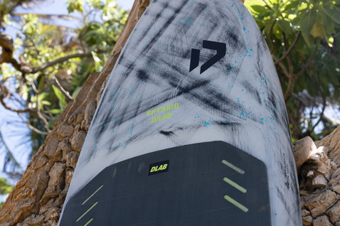 Duotone Skybrid D/LAB foil board deck detail showing carbon construction and EVA traction pad in white and dark grey