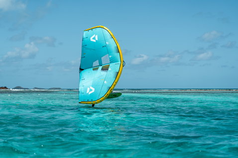 Duotone Skybrid D/LAB foil wing during wing foiling on a turquoise tropical reef lagoon