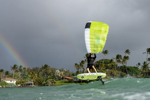 Duotone Skybrid D/LAB foil board during wing foiling on tropical coastal waters with rainbow backdrop