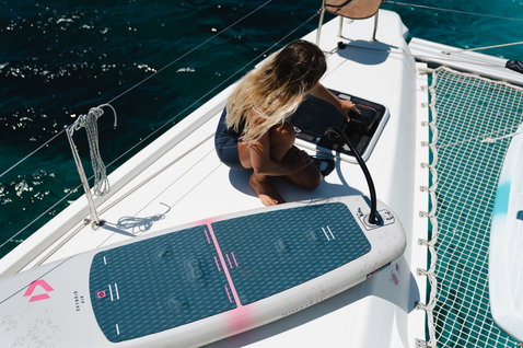 Duotone Skybrid Air foil board during wing foiling on a catamaran in the Mediterranean